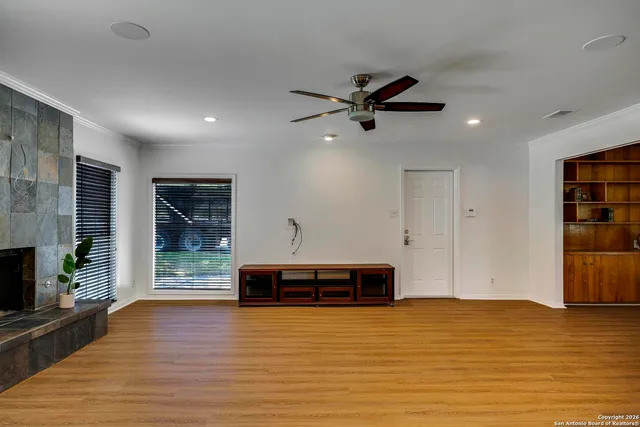 a view of a room with wooden floor and a window