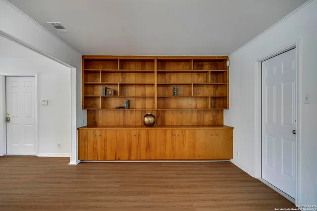 a view of wooden floor and cabinet in a room