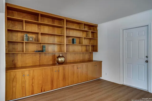 a view of a room with wooden floor and shelf
