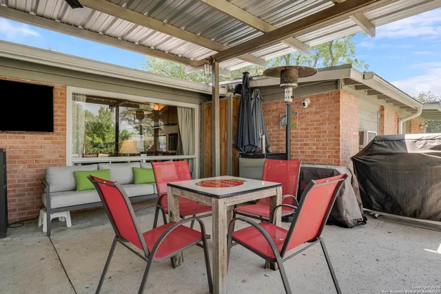 a patio with a table and chairs