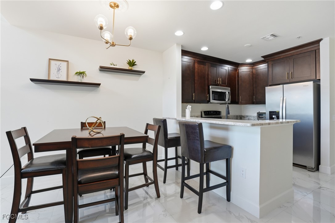 2743 First Street, Unit 109 Fort Myers, FL 33916 - Photo 11 of 27 a view of a dining room with furniture