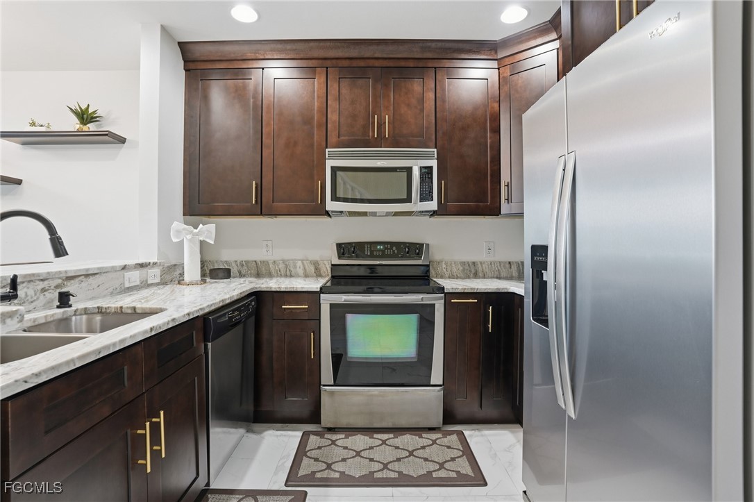 2743 First Street, Unit 109 Fort Myers, FL 33916 - Photo 12 of 27 a kitchen with a refrigerator and a sink