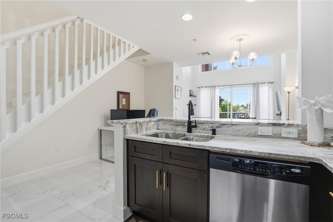 2743 First Street, Unit 109 Fort Myers, FL 33916 - Photo 14 of 27 a kitchen with granite countertop a sink and cabinets