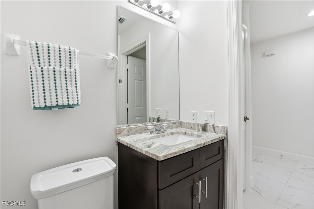 2743 First Street, Unit 109 Fort Myers, FL 33916 - Photo 17 of 27 a bathroom with a sink and a toilet