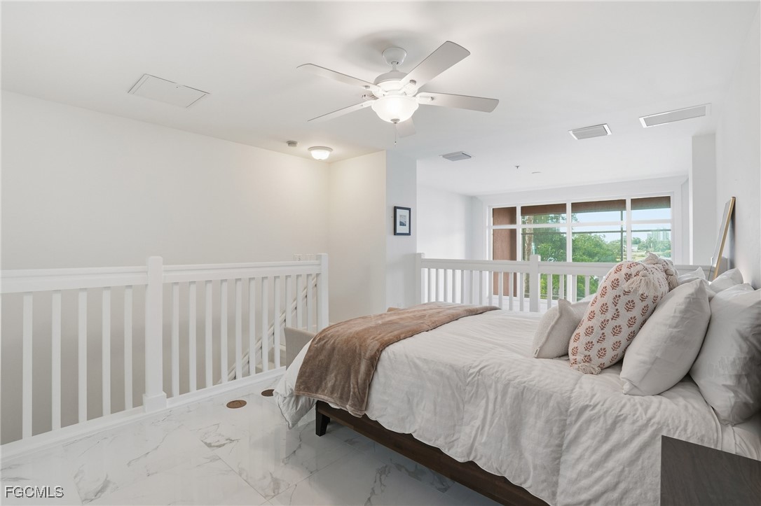 2743 First Street, Unit 109 Fort Myers, FL 33916 - Photo 19 of 27 a bedroom with a large bed and a large window