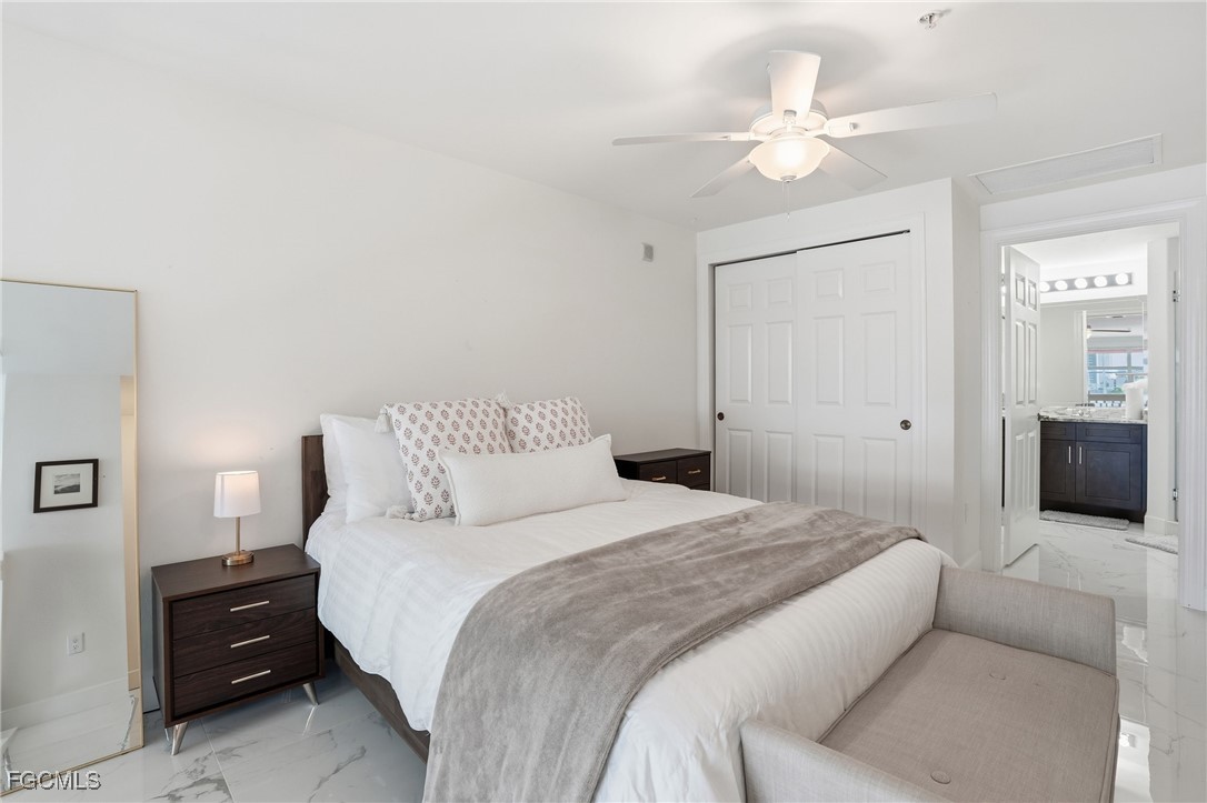 2743 First Street, Unit 109 Fort Myers, FL 33916 - Photo 20 of 27 a bedroom with a bed and a couch