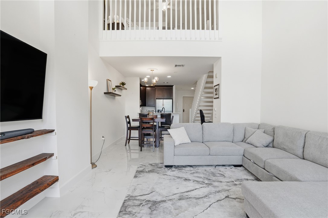 2743 First Street, Unit 109 Fort Myers, FL 33916 - Photo 2 of 27 a living room with furniture and a flat screen tv