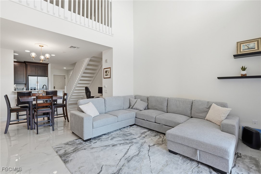 2743 First Street, Unit 109 Fort Myers, FL 33916 - Photo 6 of 27 a living room with furniture and a night stand