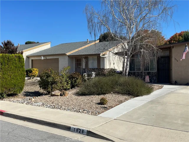 a view of a house with a small yard and plants
