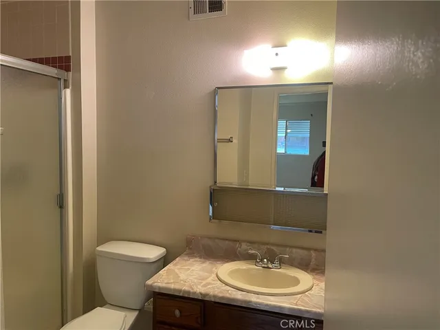 a bathroom with a sink toilet and mirror
