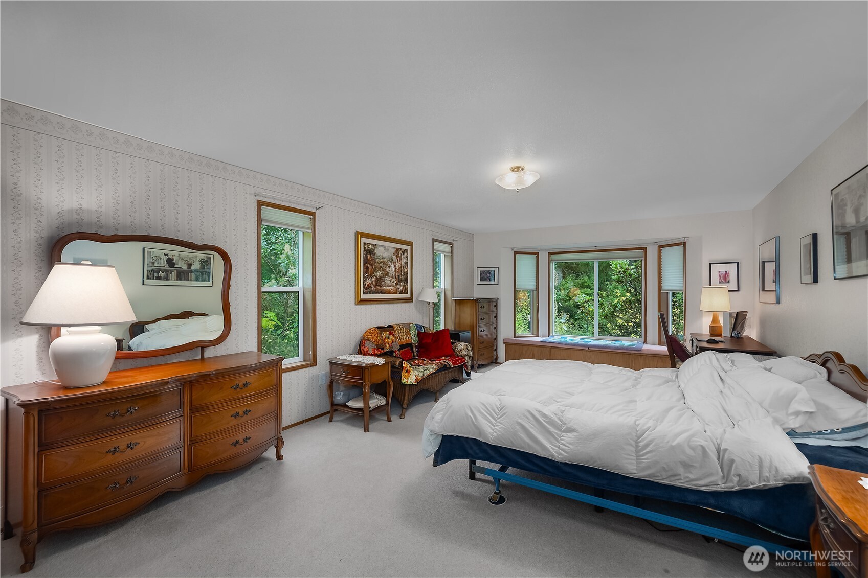 5505 Oyster Bay Road Northwest Olympia, WA 98502 - Photo 12 of 40 a bedroom with a bed and wooden floor