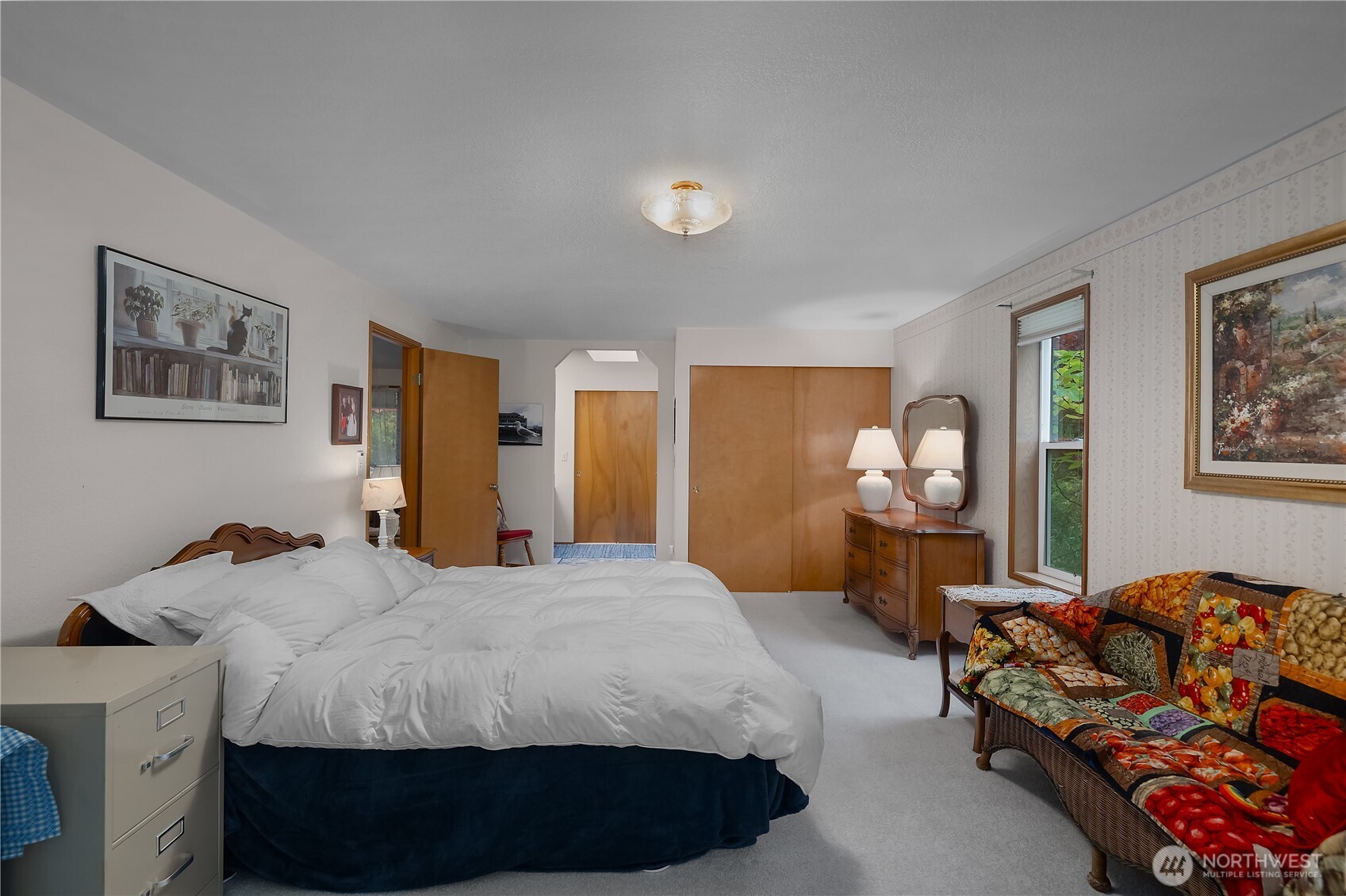 5505 Oyster Bay Road Northwest Olympia, WA 98502 - Photo 14 of 40 a spacious bedroom with a bed and dresser