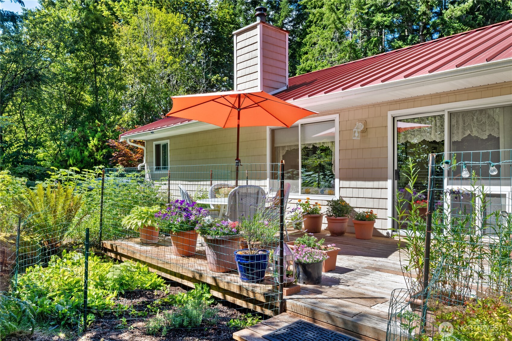 5505 Oyster Bay Road Northwest Olympia, WA 98502 - Photo 22 of 40 a view of a chair and table in backyard of the house