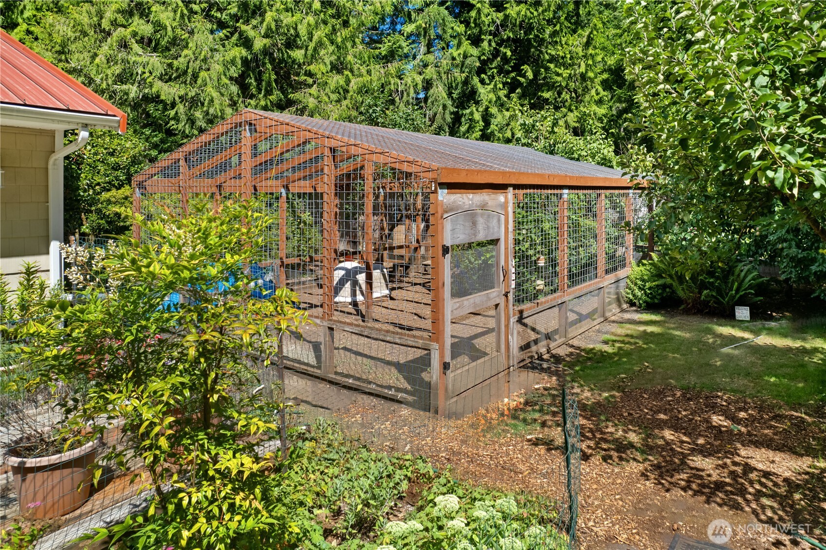 5505 Oyster Bay Road Northwest Olympia, WA 98502 - Photo 28 of 40 a view of a house with backyard and sitting area