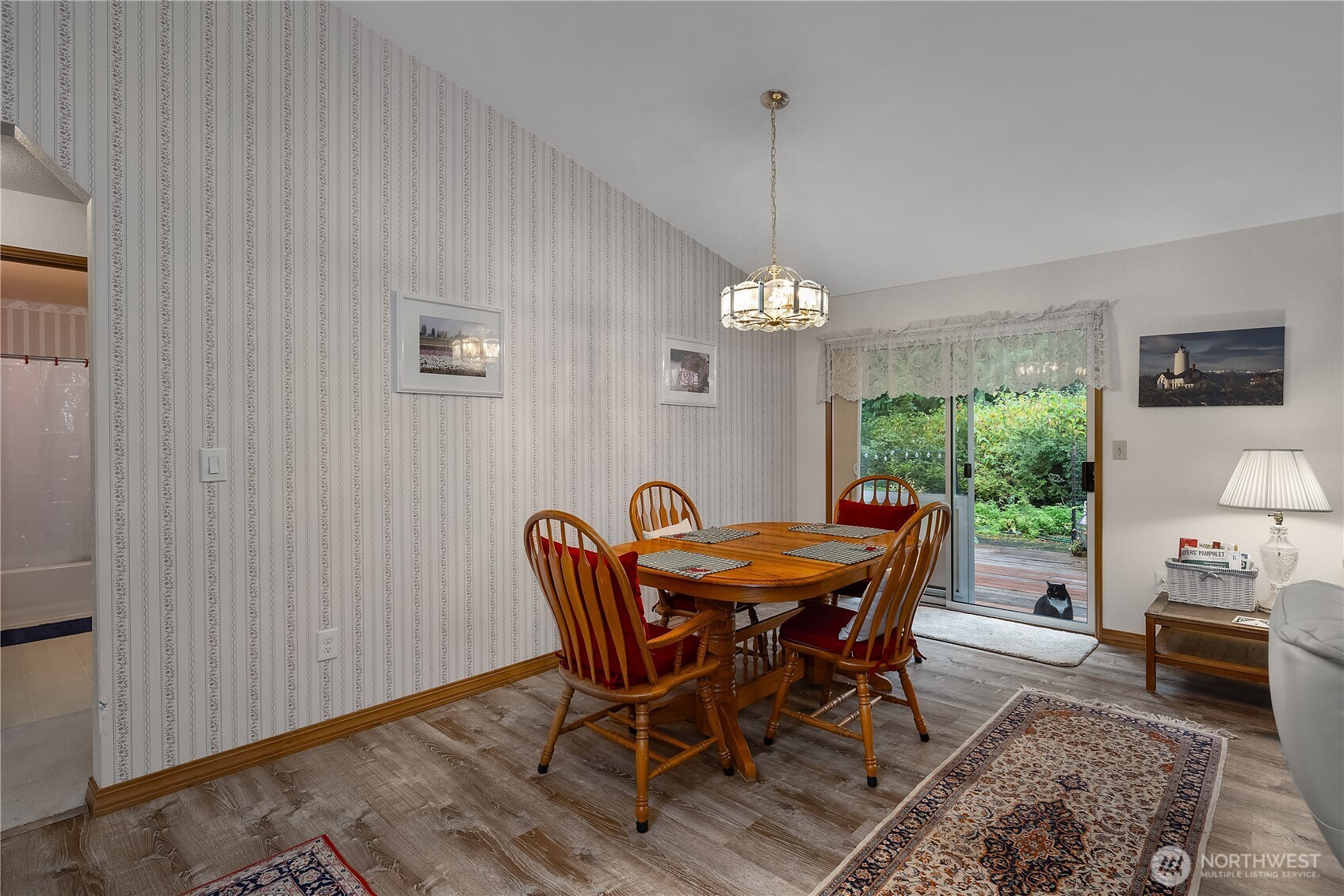 5505 Oyster Bay Road Northwest Olympia, WA 98502 - Photo 5 of 40 a view of a dining room with furniture window and wooden floor