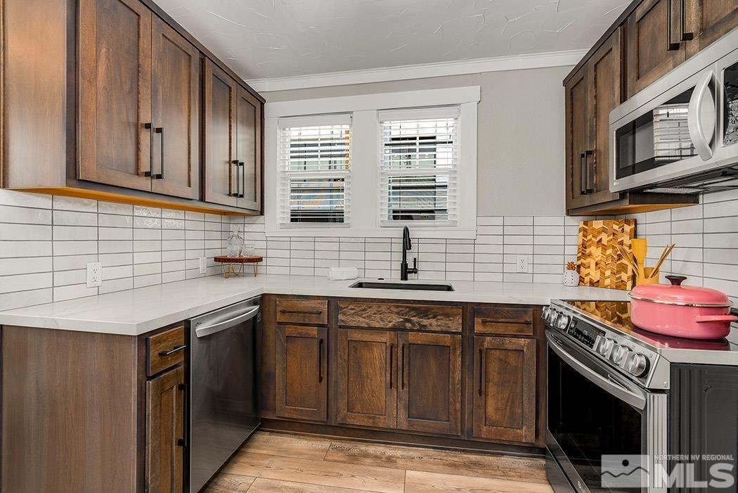 215 East Liberty Street Reno, NV 89501 - Photo 13 of 20 a kitchen with stainless steel appliances granite countertop a sink stove and cabinets