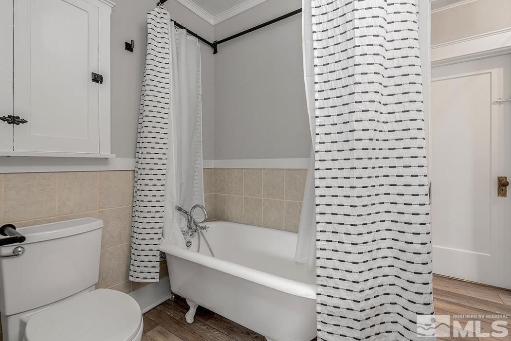 215 East Liberty Street Reno, NV 89501 - Photo 9 of 20 a white toilet sitting next to a bath tub