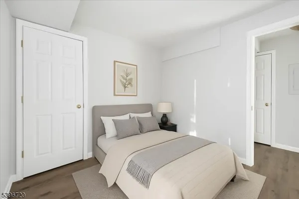 a bedroom with a bed and a painting on the wall