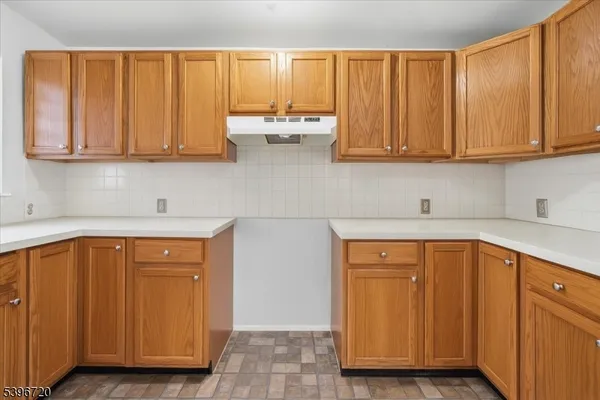 a kitchen with stainless steel appliances granite countertop wooden cabinets a sink and dishwasher