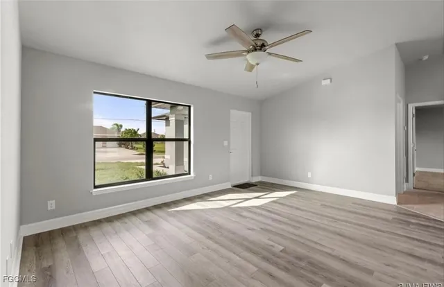 wooden floor in an empty room with a window