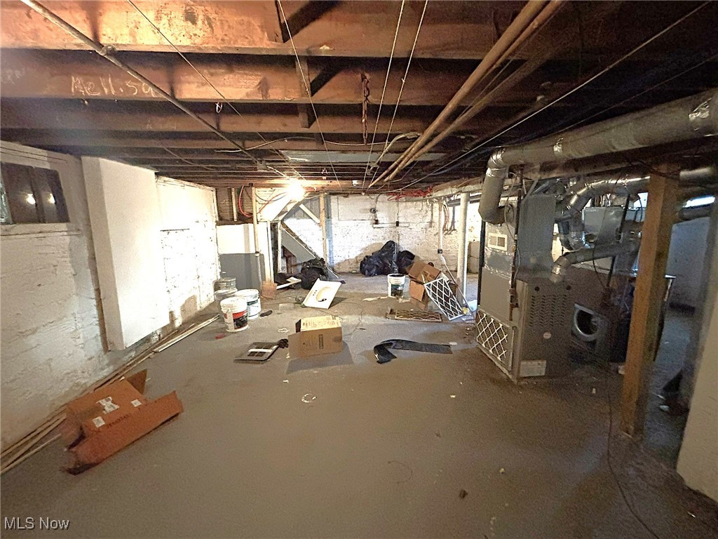888 Rondel Road Cleveland, OH 44110 - Photo 27 of 35 Unfinished basement with heating unit