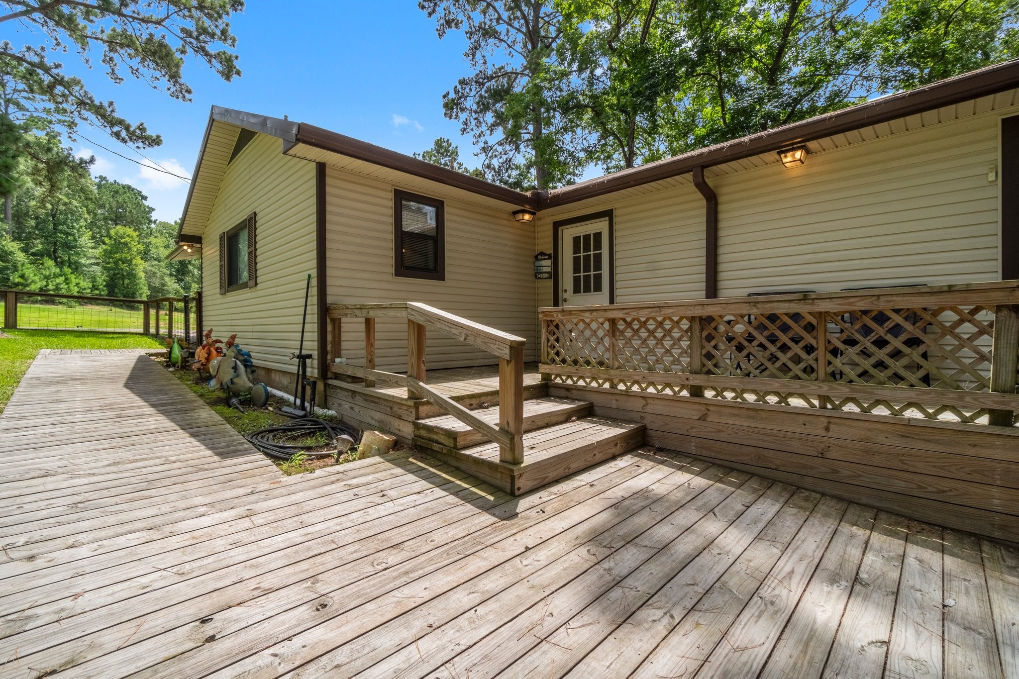 a view of a wooden deck with a yard
