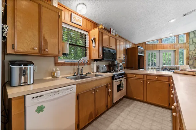 a kitchen with a sink stove and cabinets