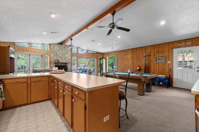 a kitchen with stainless steel appliances granite countertop a sink and a refrigerator