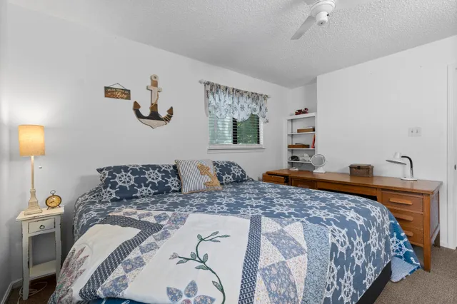 a bedroom with a large bed and a lamp