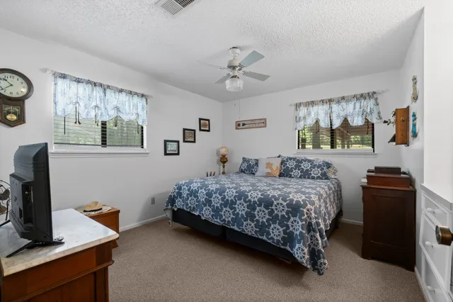 a bedroom with a bed and a desk