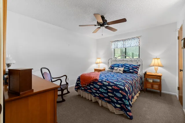 a bedroom with a bed chair and window