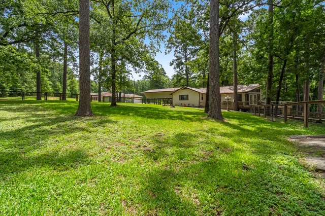 an aerial view of a house with swimming pool outdoor seating and yard