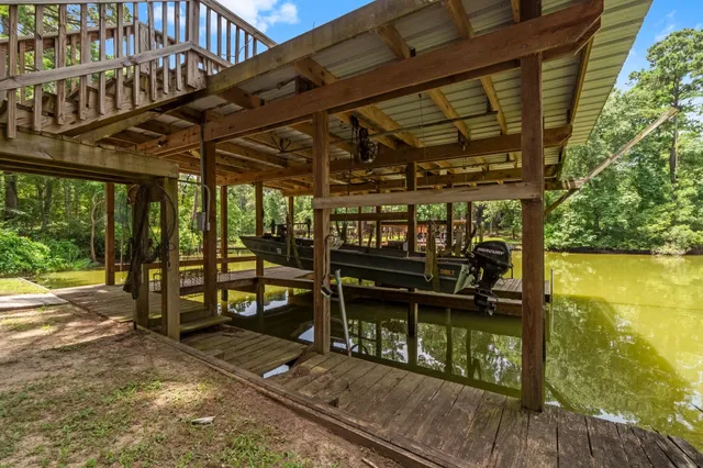 a view of a balcony with chairs and wooden floor