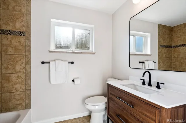 a bathroom with a sink toilet and a mirror