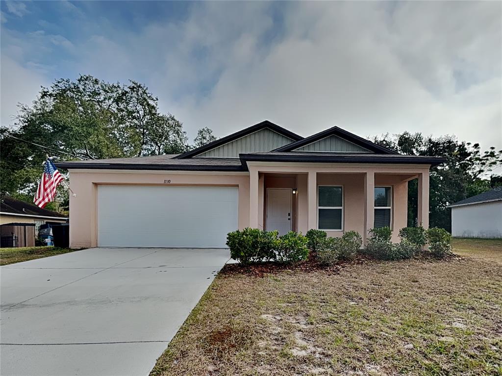 Undisclosed Address Spring Hill, FL 34608 - Photo 1 of 17 a front view of a house with garden