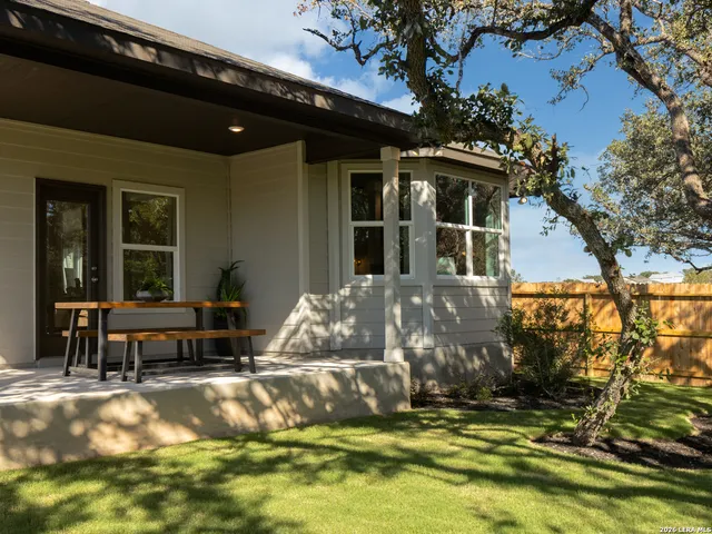 a view of a house with swimming pool and sitting area