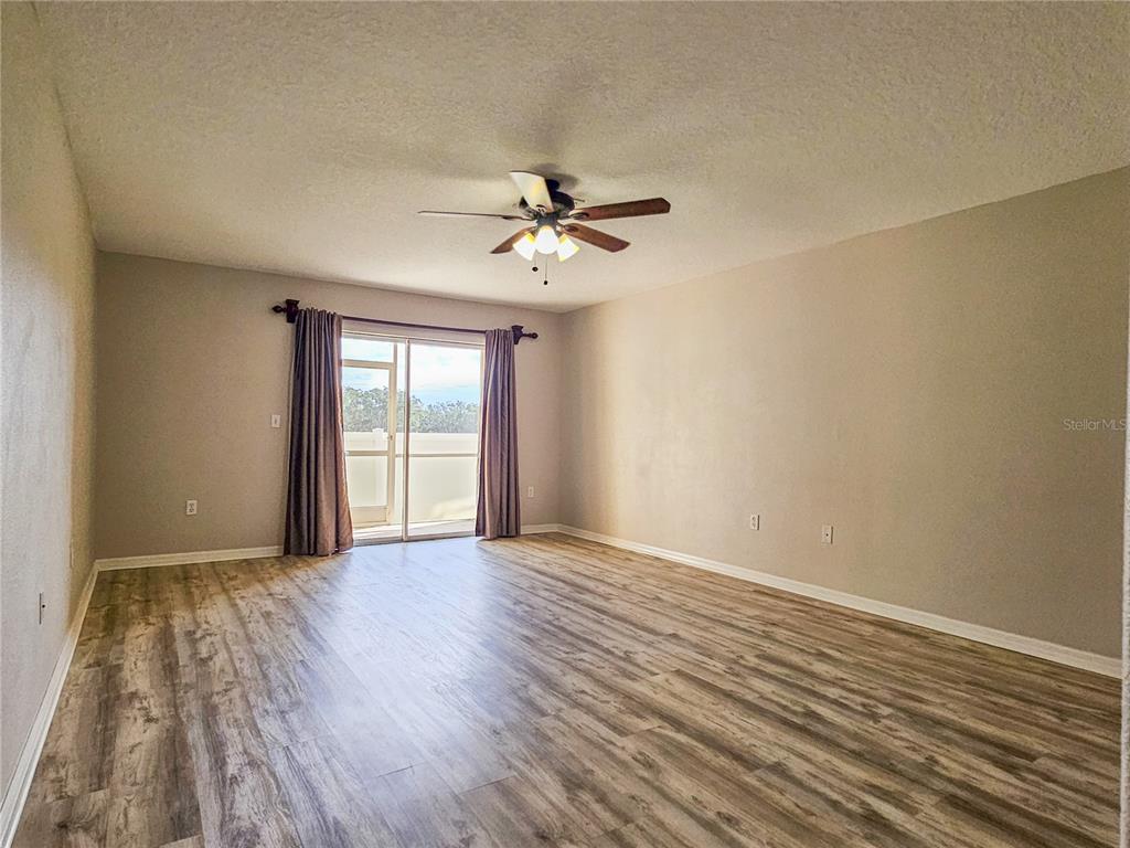 5383 Quarry Rock Road Lakeland, FL 33809 - Photo 12 of 23 wooden floor in an empty room with a window