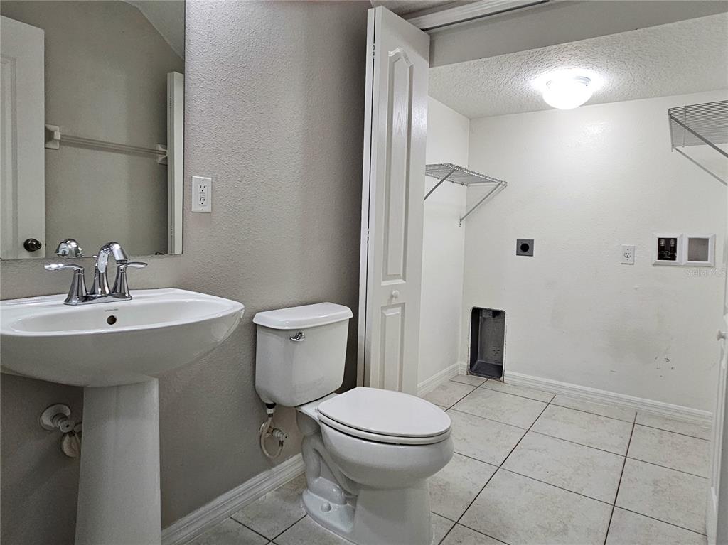 5383 Quarry Rock Road Lakeland, FL 33809 - Photo 13 of 23 a bathroom with a sink a toilet and shower