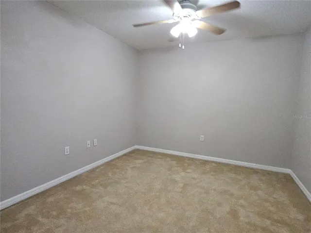 a view of an empty room with a fan