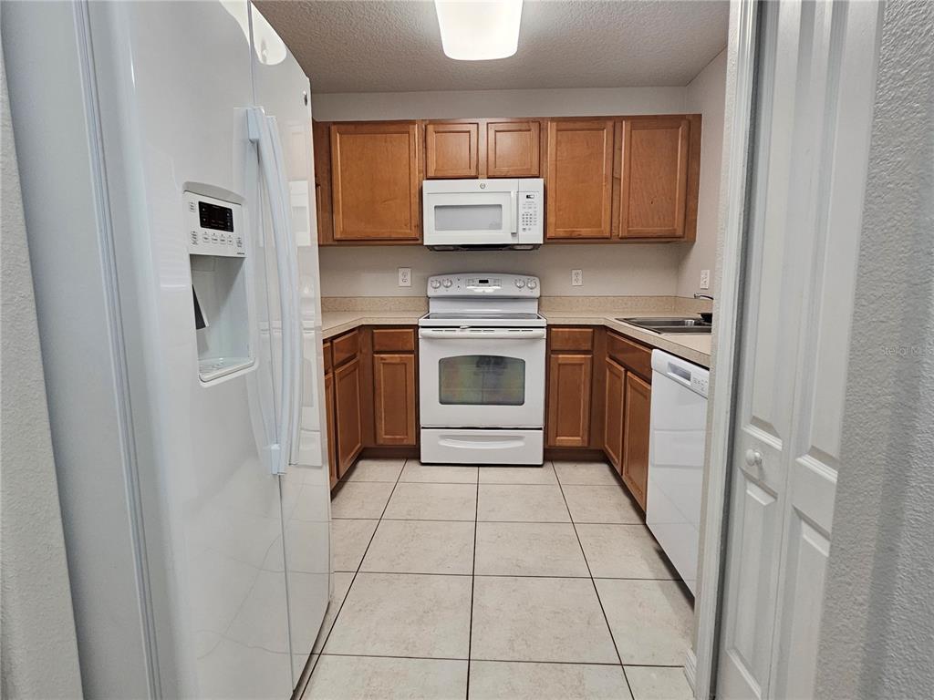 5383 Quarry Rock Road Lakeland, FL 33809 - Photo 5 of 23 a kitchen with stainless steel appliances granite countertop a refrigerator and a stove top oven