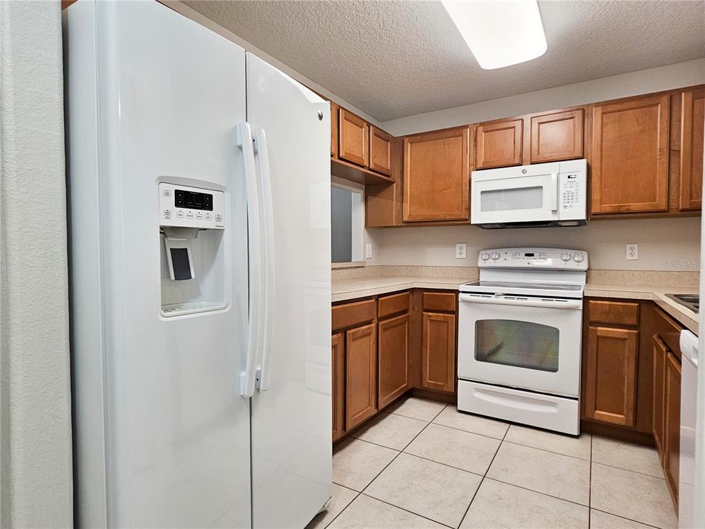 5383 Quarry Rock Road Lakeland, FL 33809 - Photo 6 of 23 a kitchen with cabinets stainless steel appliances and a window