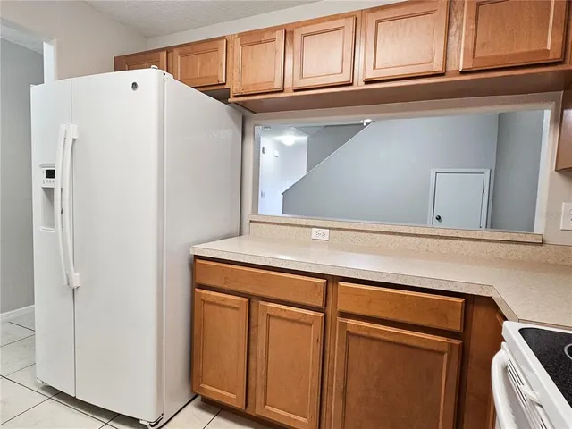 a white refrigerator freezer sitting inside of a kitchen