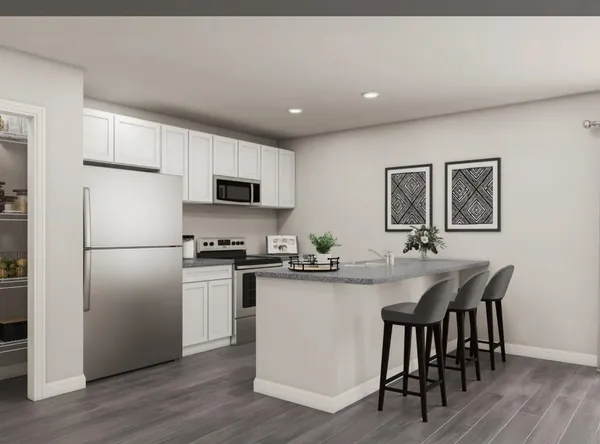 a kitchen with refrigerator cabinets and wooden floor