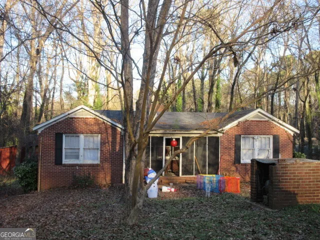 a front view of a house with yard and tree s