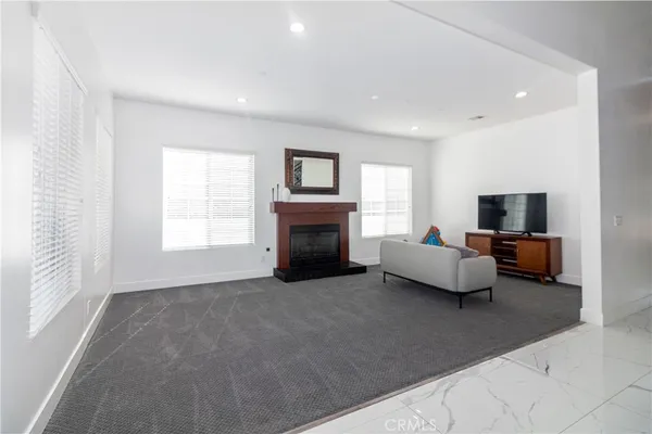 a kitchen with stainless steel appliances kitchen island granite top and refrigerator