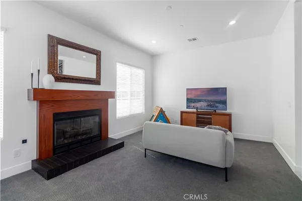 a kitchen with granite countertop a sink stainless steel appliances and window