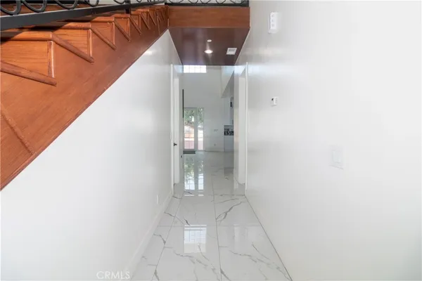 a bathroom with a granite countertop toilet a sink and a mirror