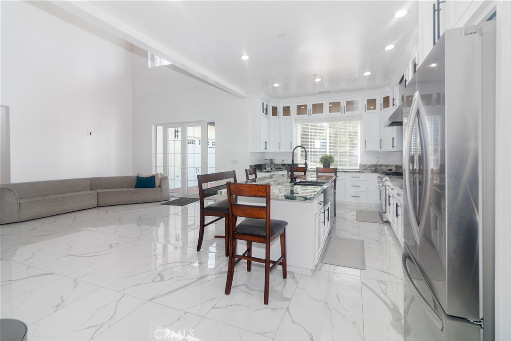17423 Wicker Way Riverside, CA 92504 - Photo 15 of 66 a living room with stainless steel appliances furniture a rug and a kitchen view