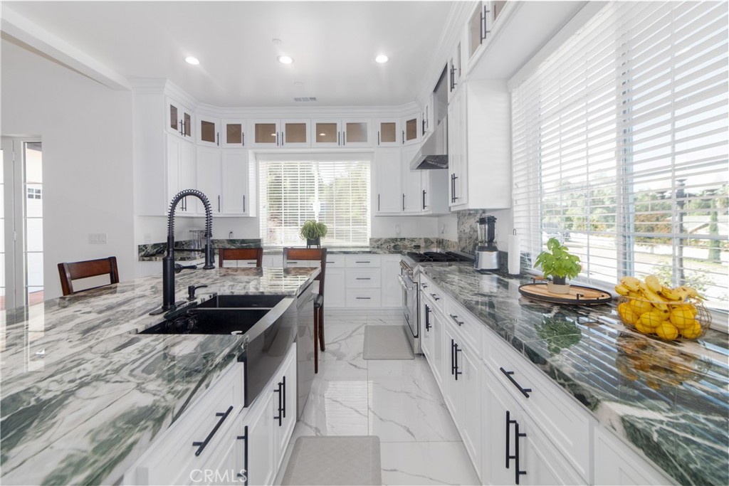 17423 Wicker Way Riverside, CA 92504 - Photo 18 of 66 a kitchen with granite countertop a sink stainless steel appliances and window