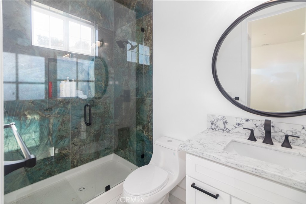 17423 Wicker Way Riverside, CA 92504 - Photo 21 of 66 a bathroom with a sink a toilet and a mirror